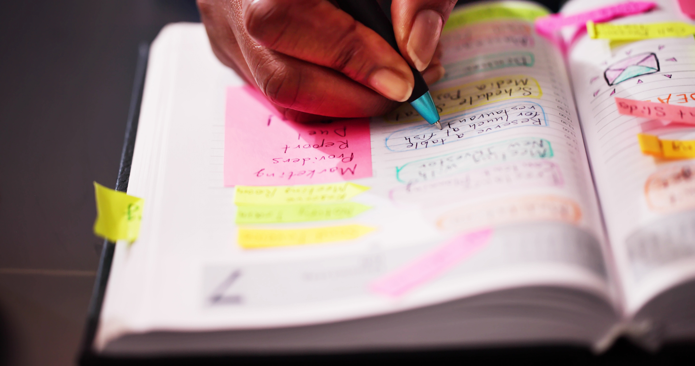 image of hand writing on post-it notes