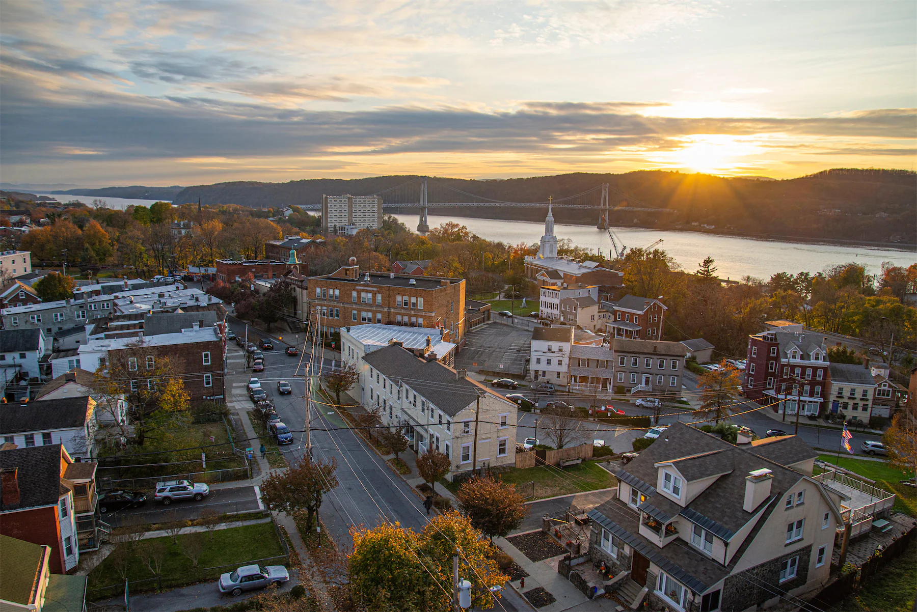 A wide landscape photo of a small town in the Hudson Valley at sunset