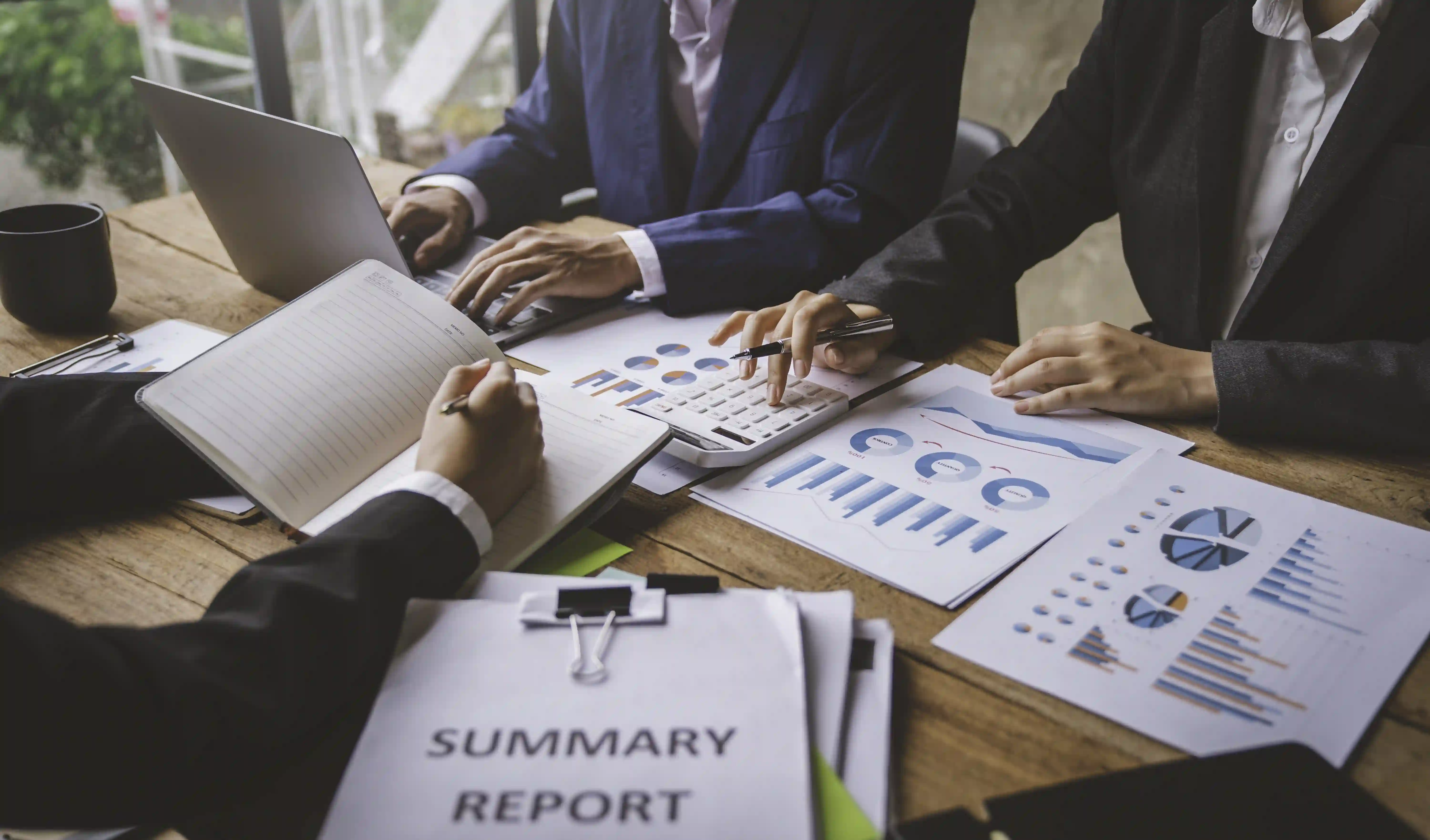 Business professionals collaborating on a summary report