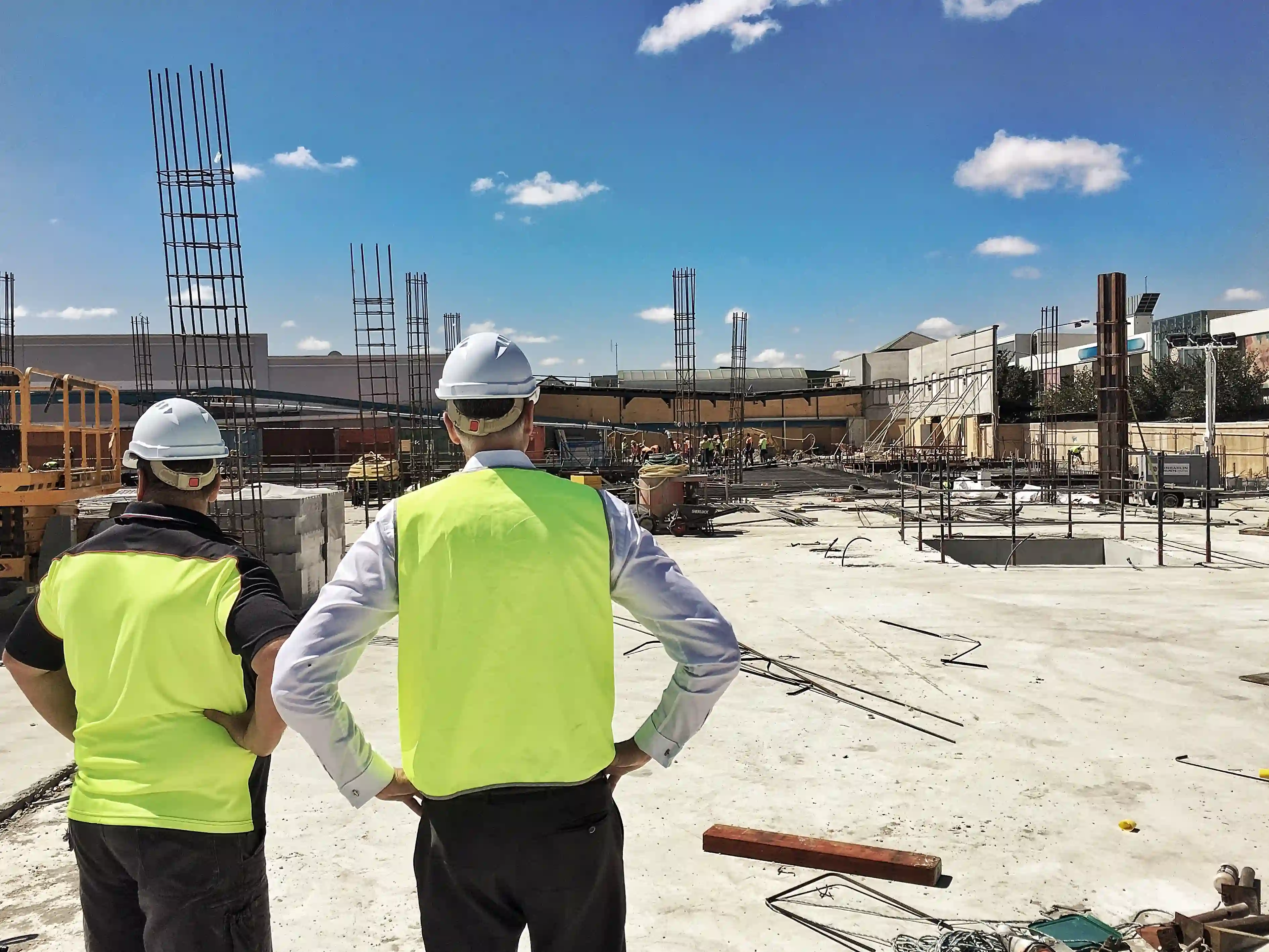 Construction workers surveying a site development