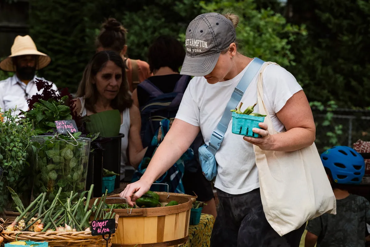 A farm-fresh fan picks out the perfect peppers to buy from the local farmers.