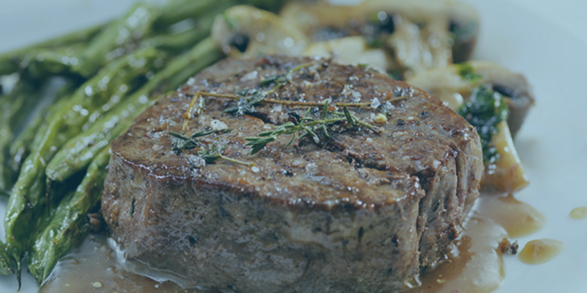 steak on plate with veggies.