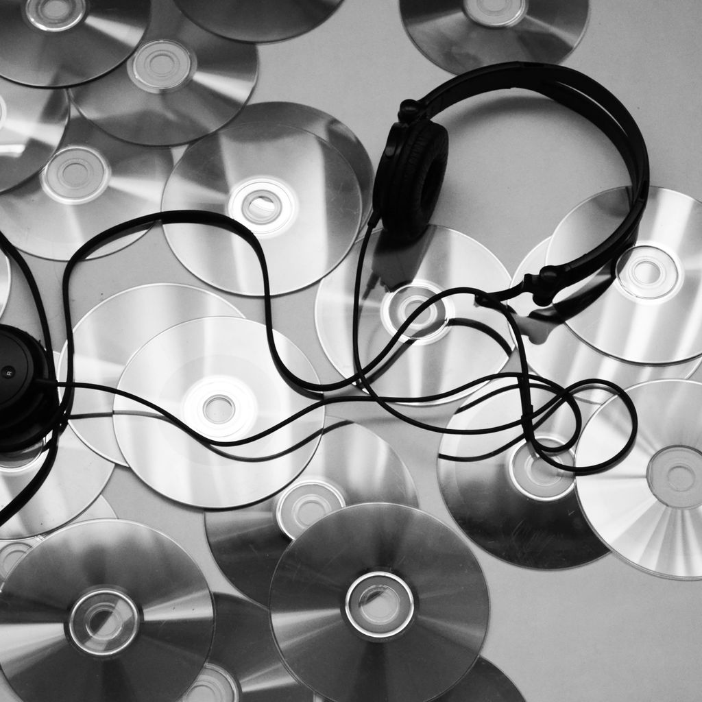 black corded headphones on white surface