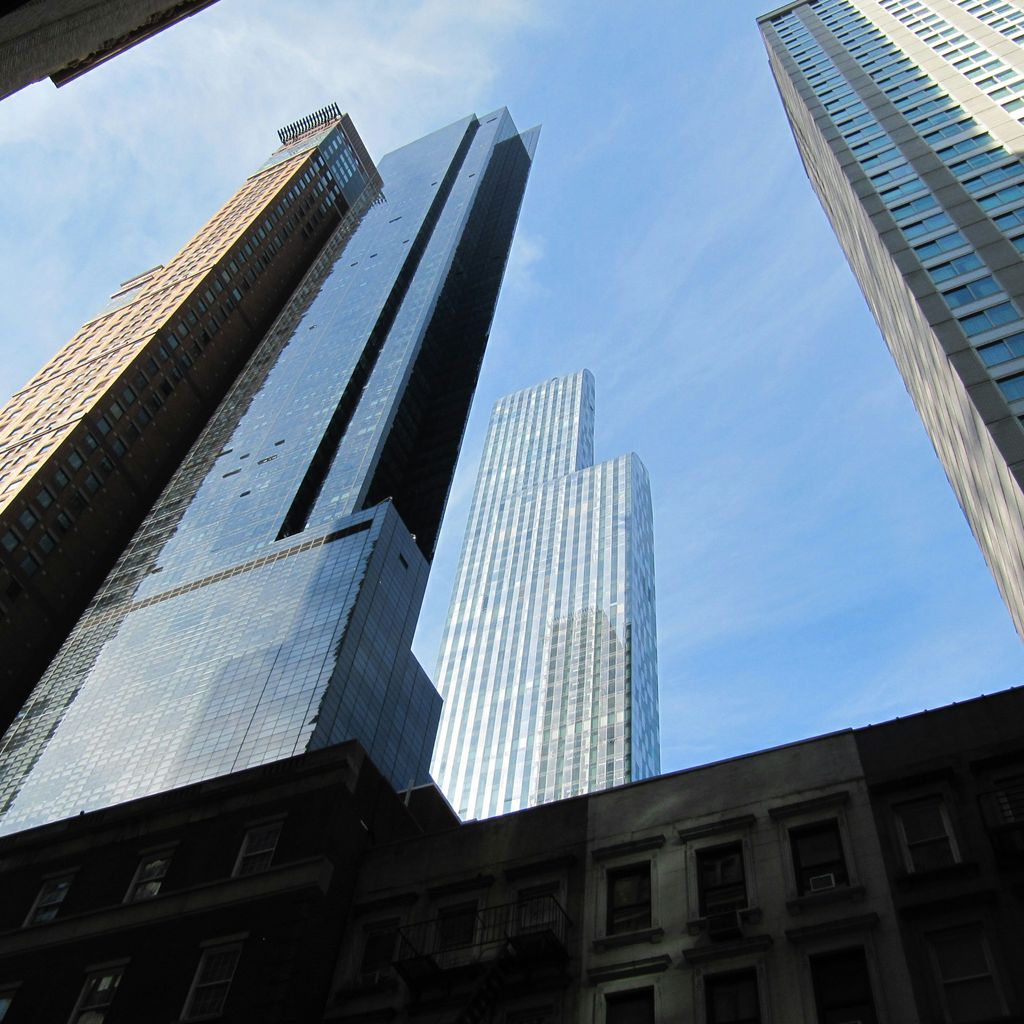 looking up at tall buildings in a city