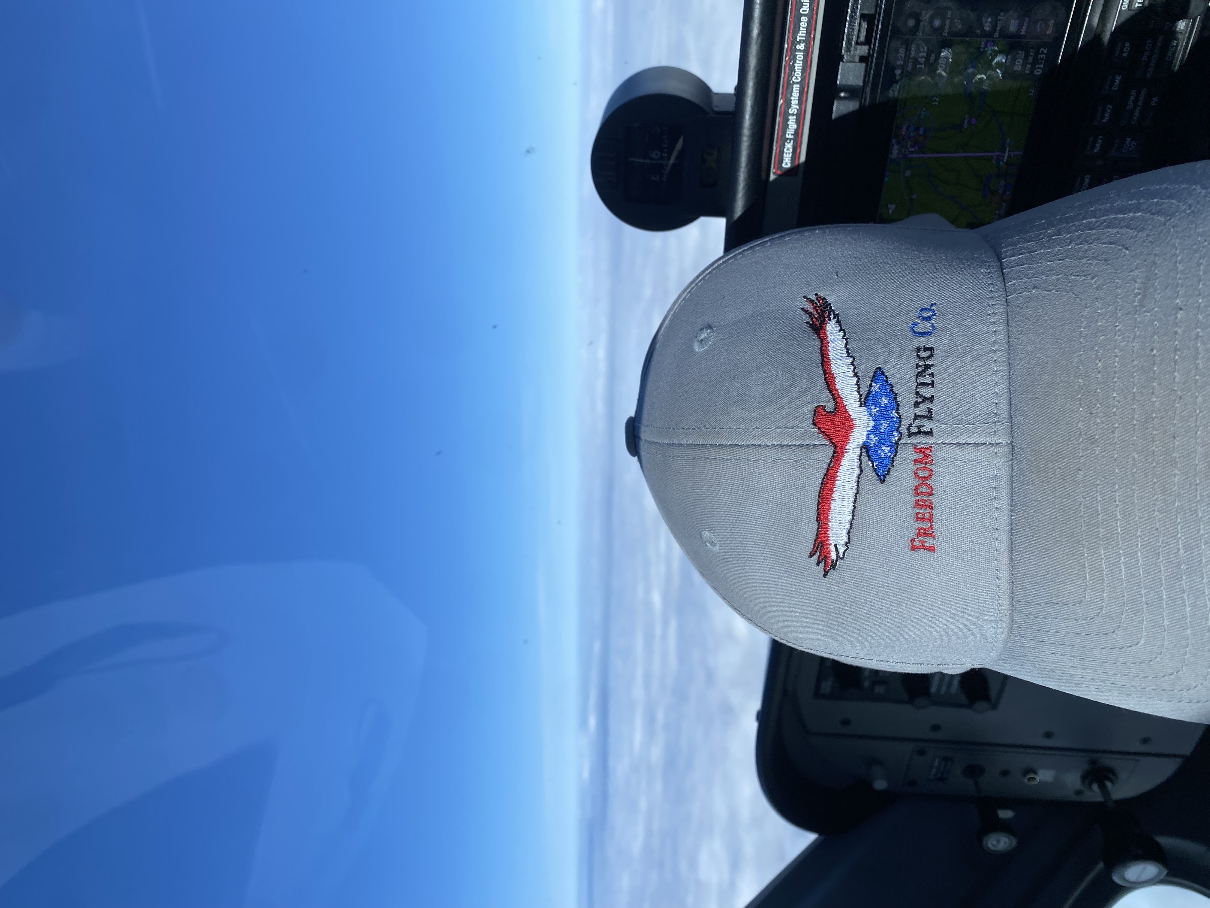 ffc hat on dashboard of plane