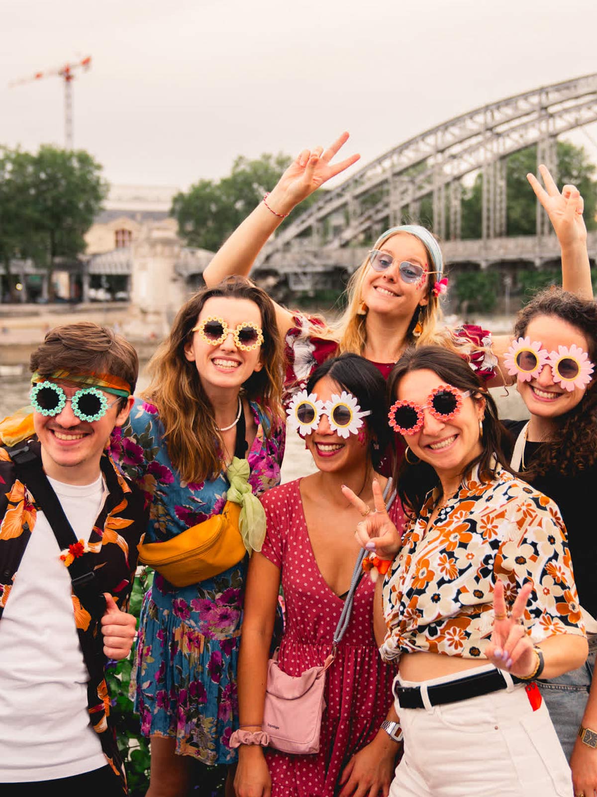 Crowd smiling and waving during a daytime group photo.