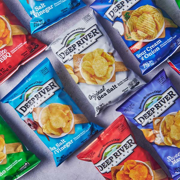 Assorted Deep River potato chip bags arranged on a light gray surface.