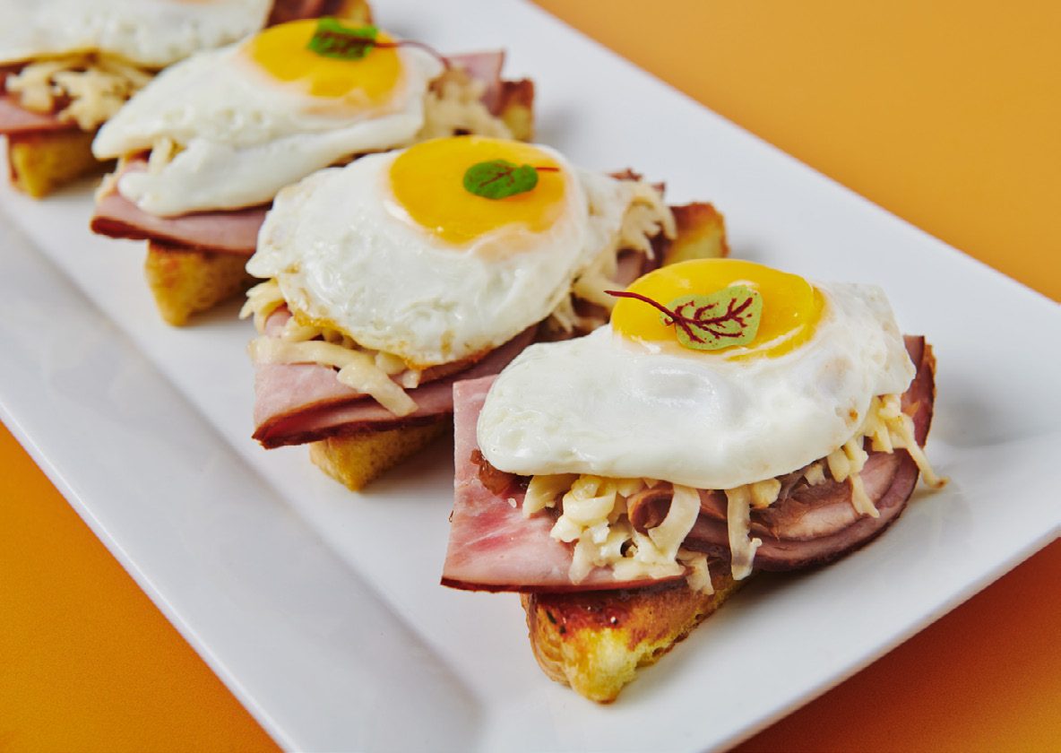 Challah tartine with smoked ham, gruyere and fried egg
