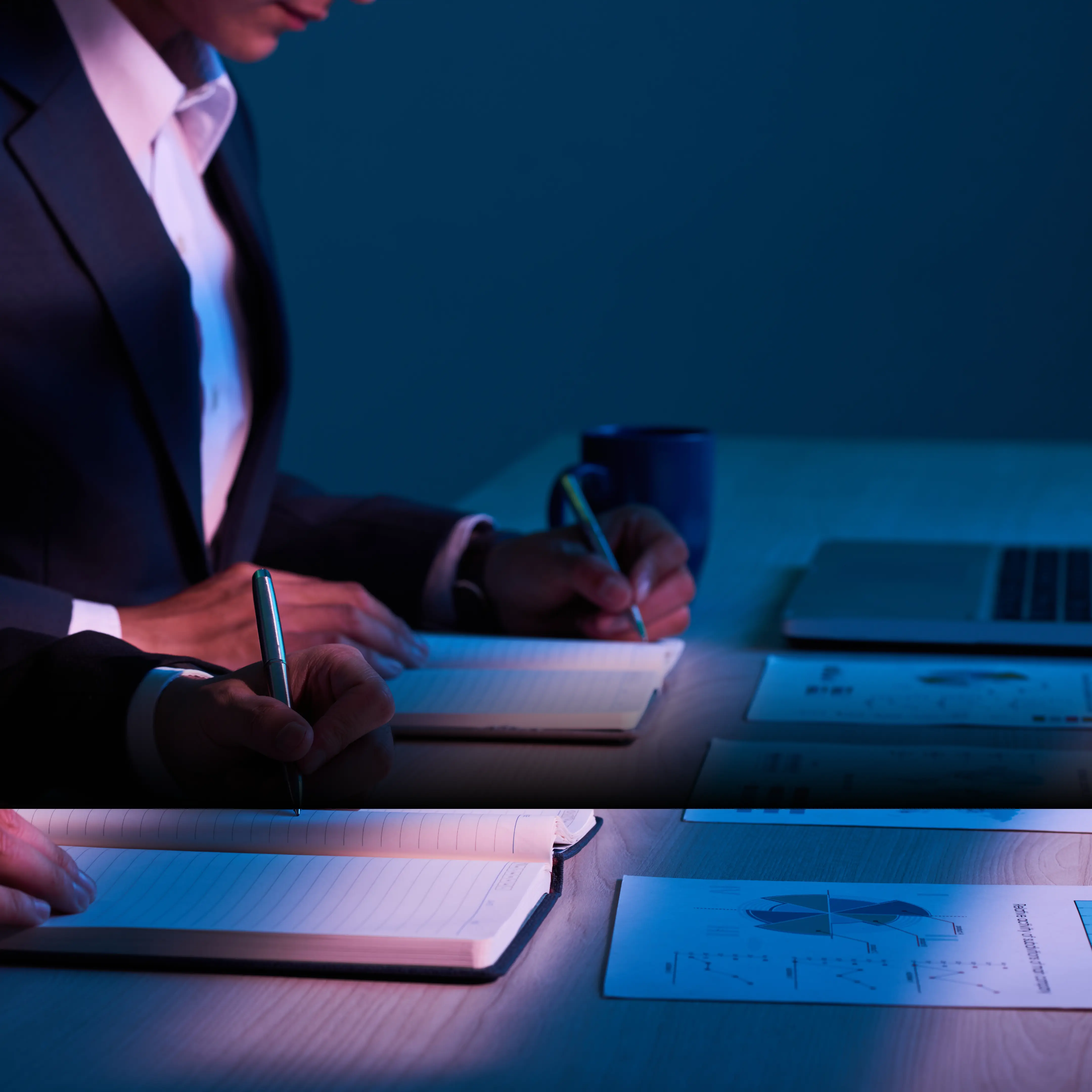 Person reviewing and comparing multiple printed versions of a software agreement to identify changes