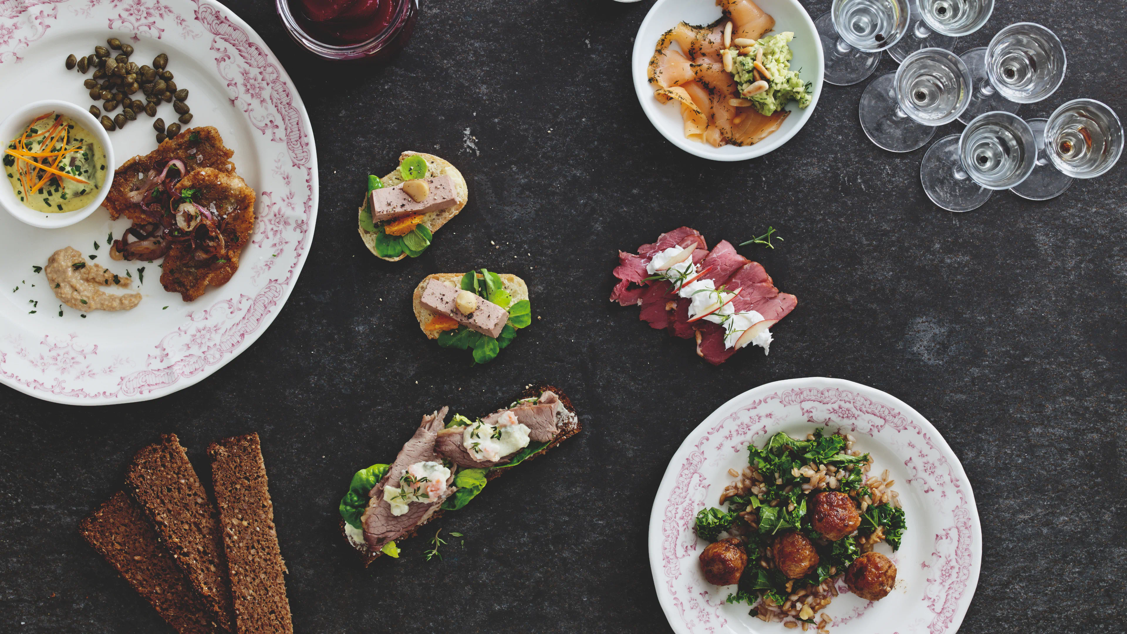 Food table with smørrebrød and traditional dishes from the SuperBrugsen In-store Digital Wine Universe, used for wine pairing experiences.