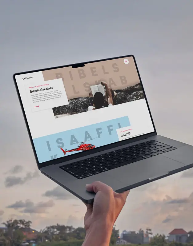 Linkfactory website shown on a laptop held outdoors, presenting a minimal digital portfolio with bold typography, layered storytelling, and a concept-driven visual identity.