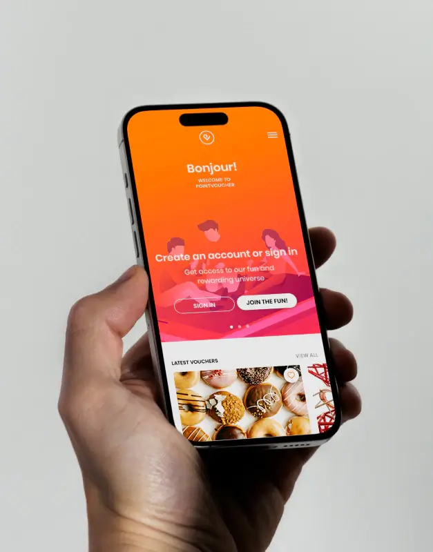 Pointvoucher mobile app shown in hand on a smartphone, showcasing a vibrant reward platform interface with onboarding, voucher discovery, and a playful consumer-focused digital experience.
