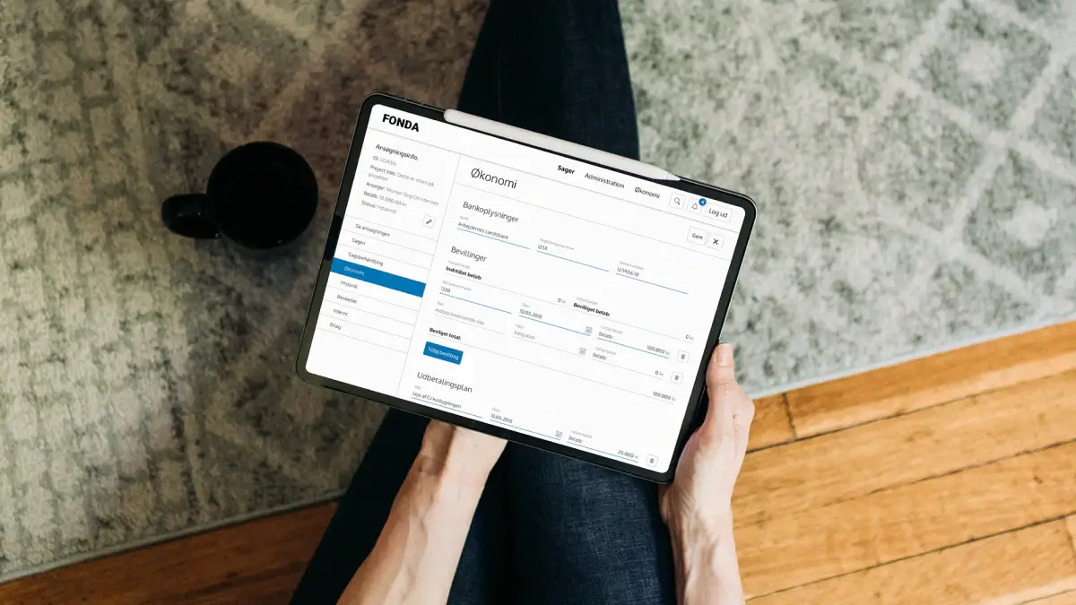 Tablet mockup showing the FONDA platform’s finance overview, with case management navigation, banking details, approvals, and payment planning in a structured administrative interface.