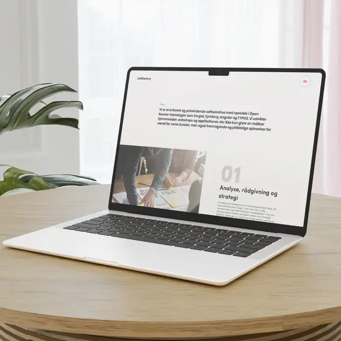 Laptop mockup of the Linkfactory website, showing a clean agency page with large typography, editorial imagery, and a structured presentation of strategy and digital services.