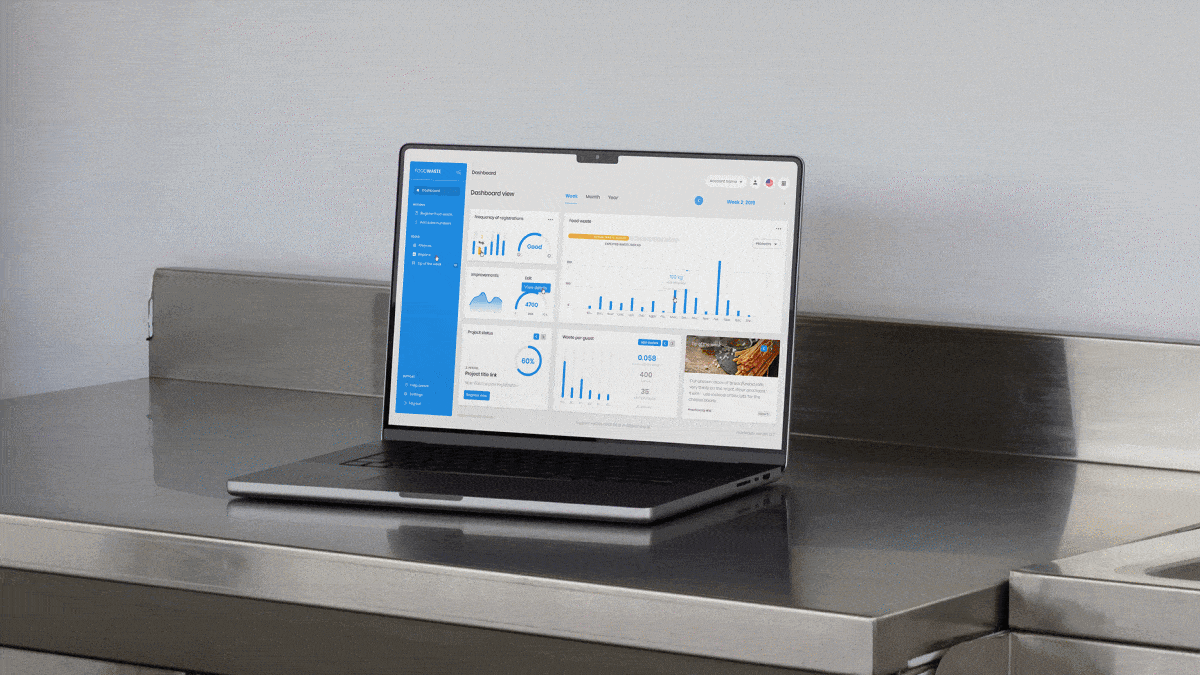 Animated laptop mockup showing the FoodWaste platform dashboard, with data visualisations, key metrics, project tracking, and a structured interface for monitoring food waste insights.