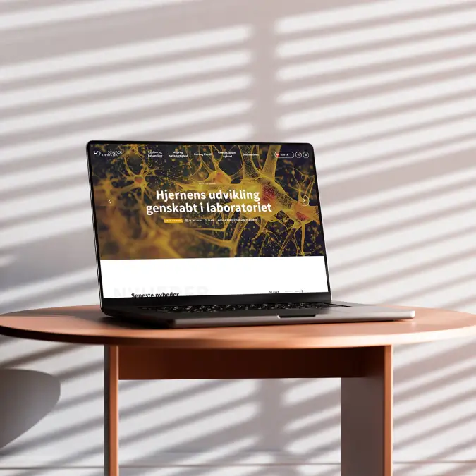 Laptop mockup showing the ScienceNews.dk homepage, featuring a prominent science article, editorial imagery, and a modern digital news interface.