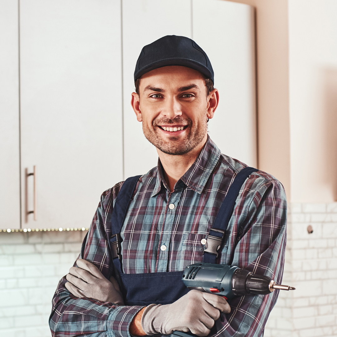 Handyman fixing a door hinge in a residential home