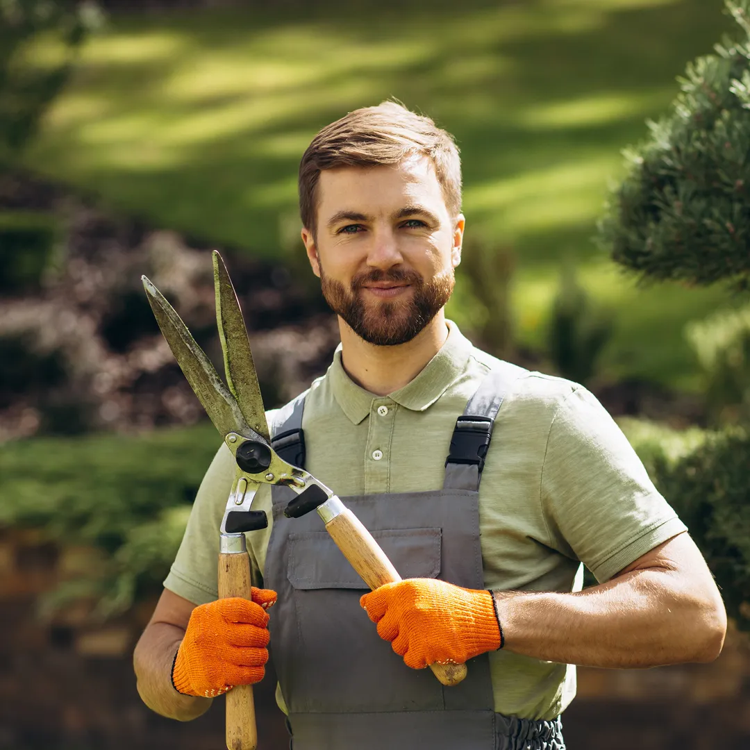 Landscaper installing patio stones in a residential backyard