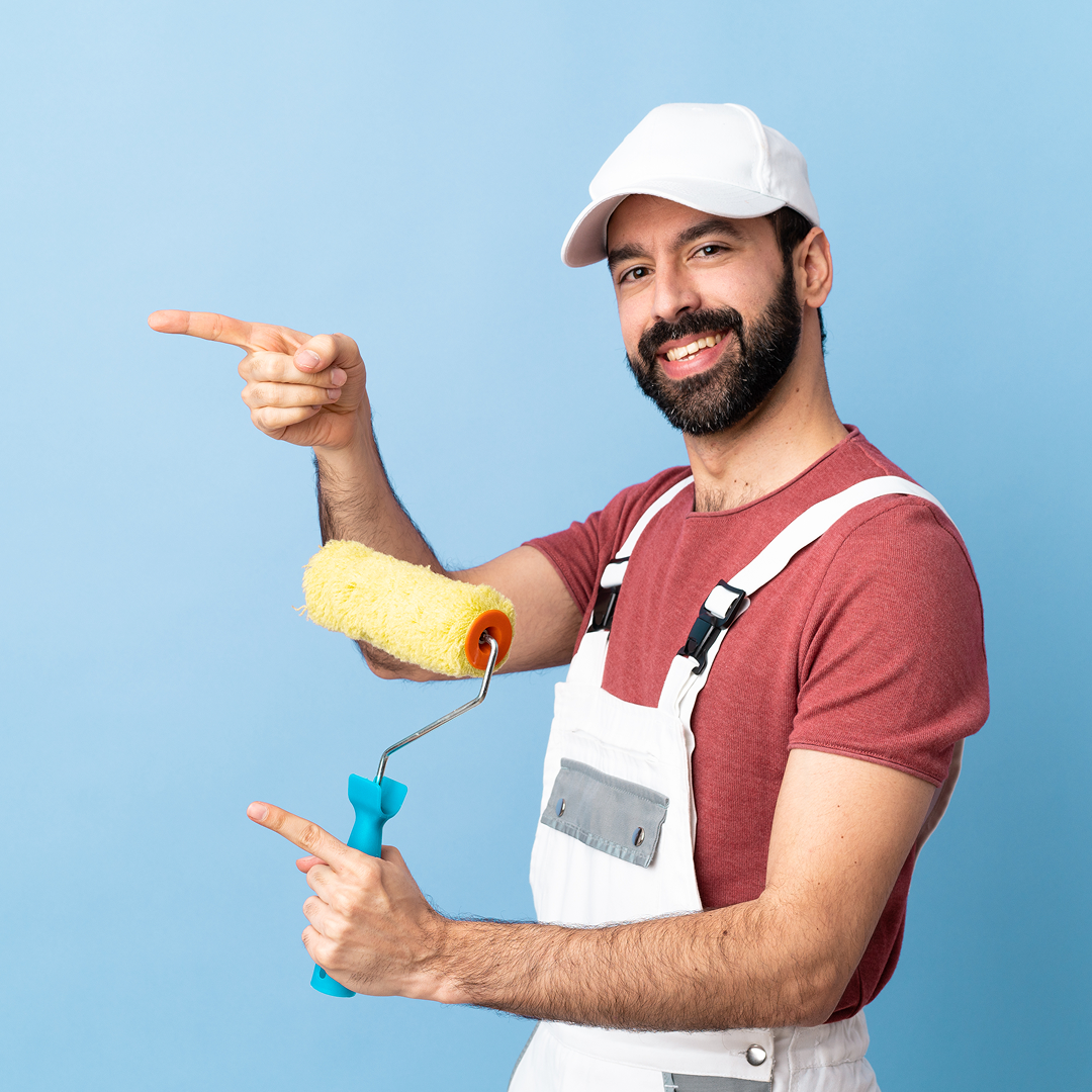 Professional painter applying color to an interior living room wall