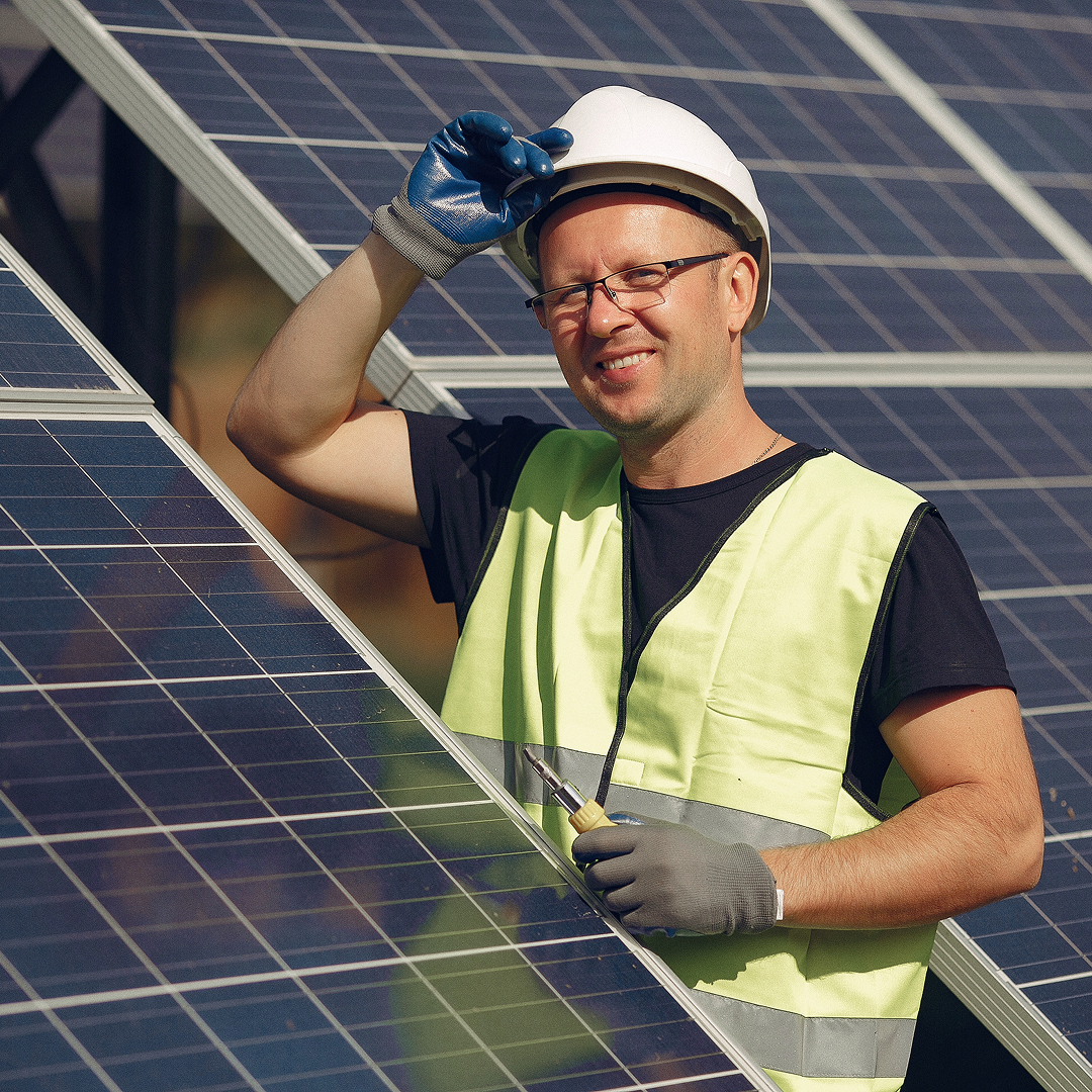 Solar installer fitting rooftop panels in a suburban neighborhood