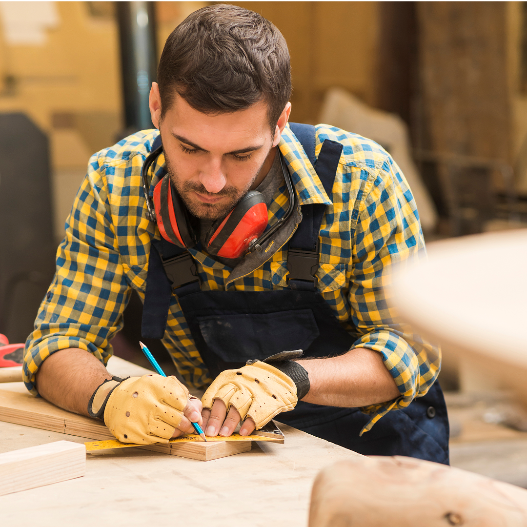  Carpenter measuring wood plank for a custom furniture project