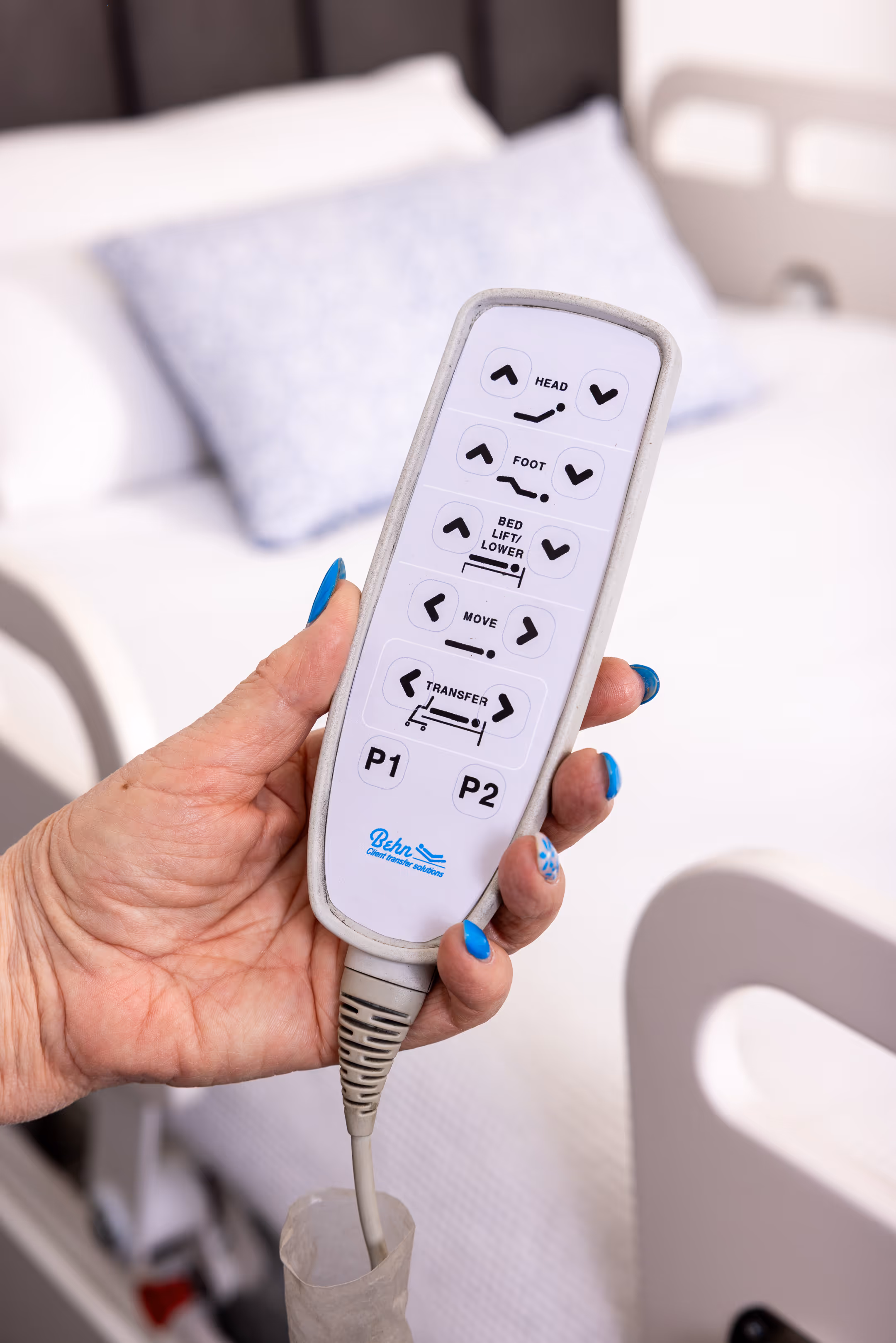 Close-up of Behn® remote used to control automated, smooth and supported glide transfer from bed to chair