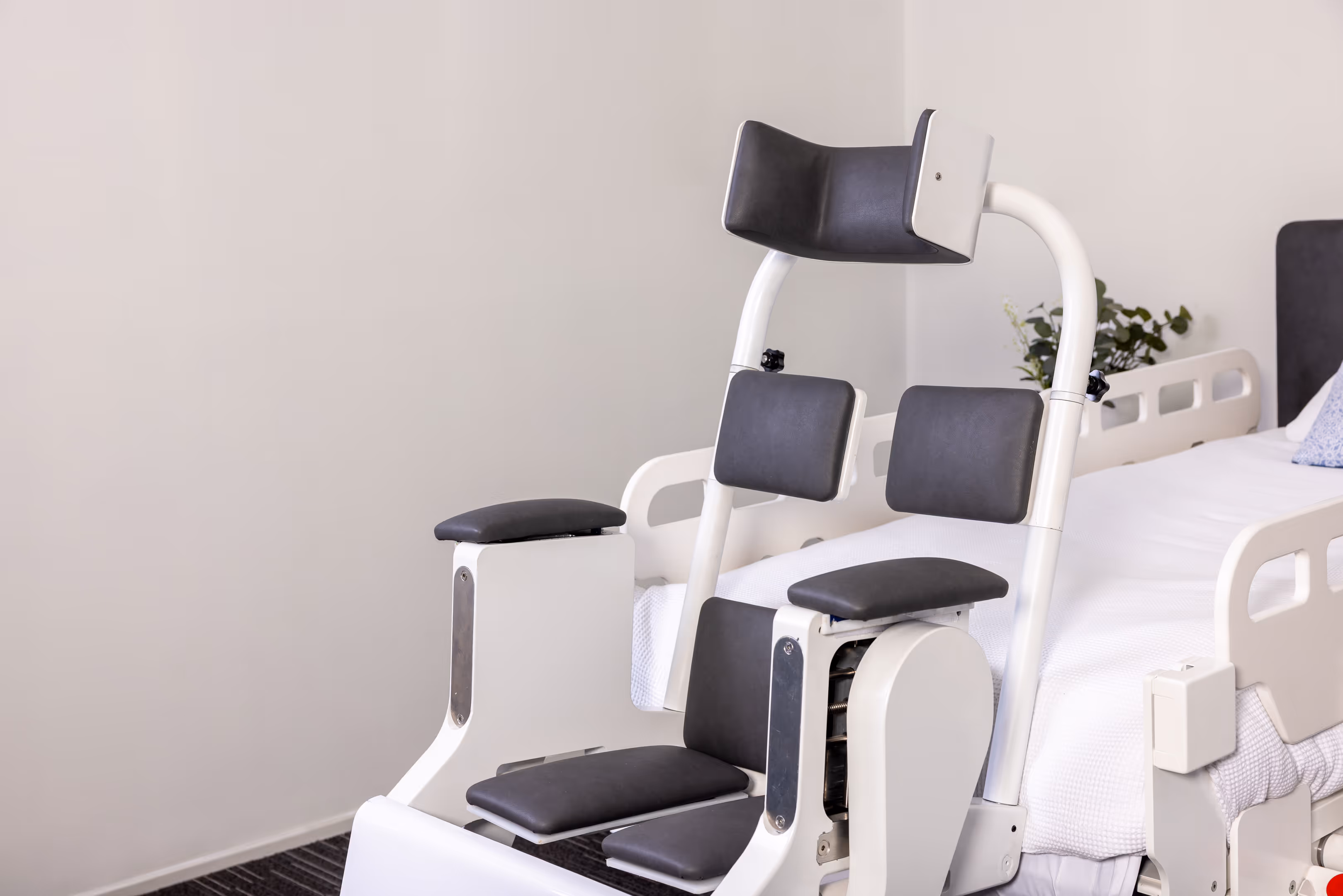 Behn® chair docked to bed in front-facing position, showing integrated setup for assisted transfer