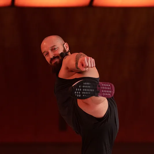Les Mills instructor Dan Cohen performs a high kick