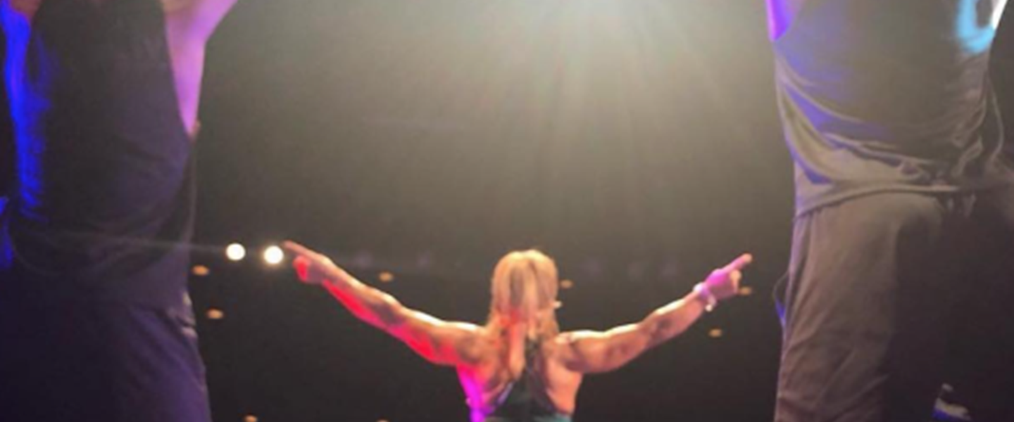 Lisa Osborne leading on stage