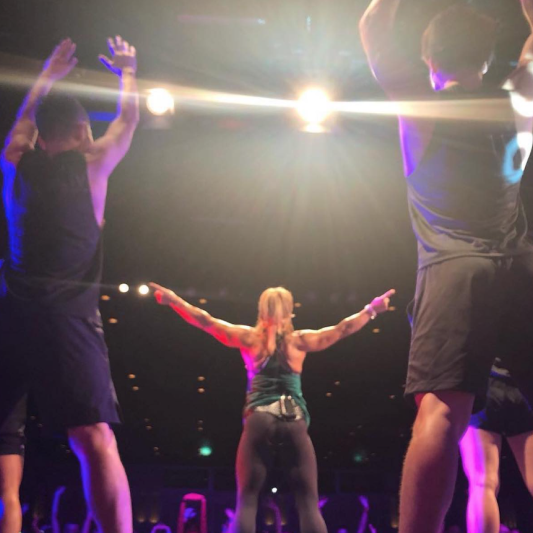 Lisa Osborne leading on stage