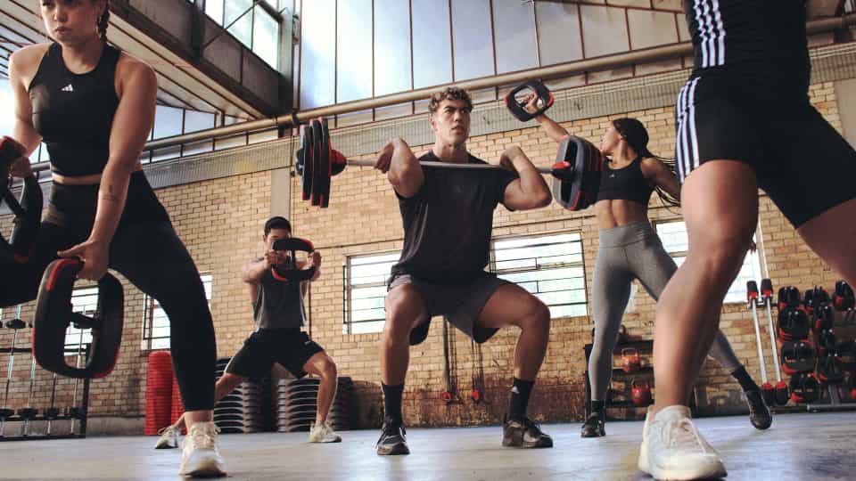 Group of people working out at a gym using different equipment
