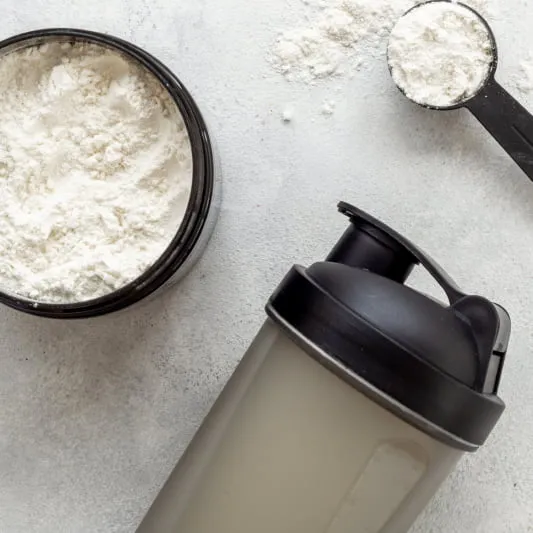 Powdered food in a jar and a spoon with a shaker