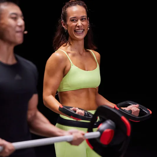 Two Les Mills Instructors holding SmartBar and plates