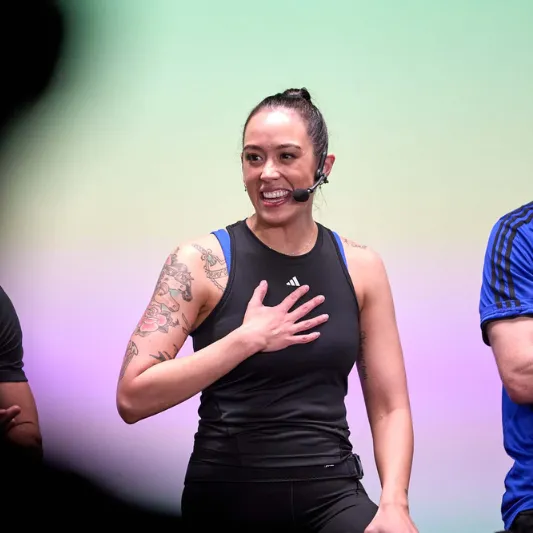 Instructor with hand on chest talking to audience