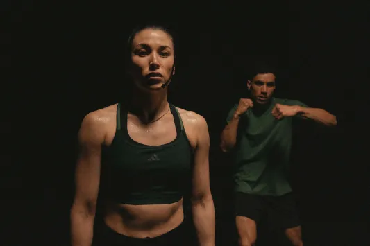 Two instructors demonstrating BodyCombat workout moves