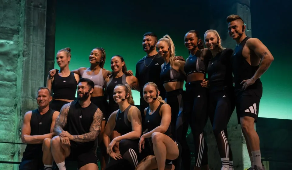 Group of Les Mills Shapes instructors dressed in adidas workout gear posing at the end of a workout for audience