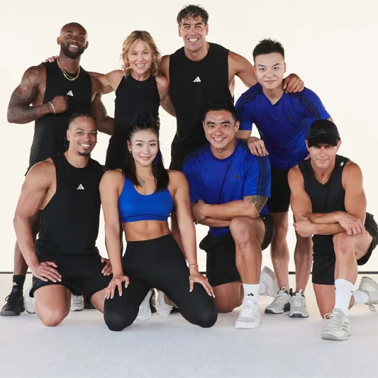 A group of instructors smiling at the camera having just completed a BodyPump workout