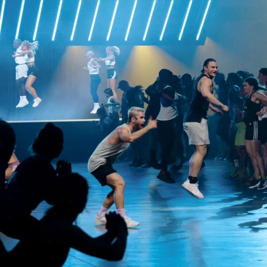 A group of Instructors demonstrating a BodyAttack workout