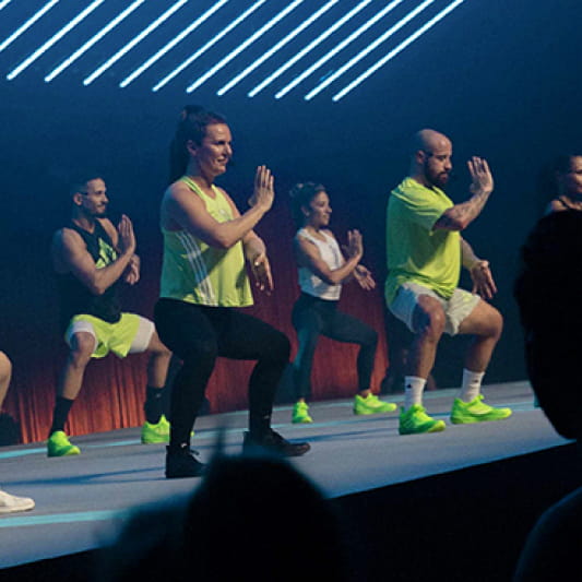 A group of Instructors demonstrating a BodyCombat workout