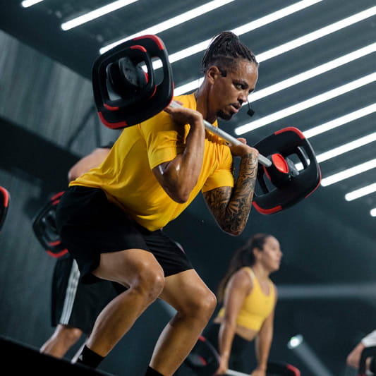 A group of Instructors demonstrating a Les Mills Grit workout
