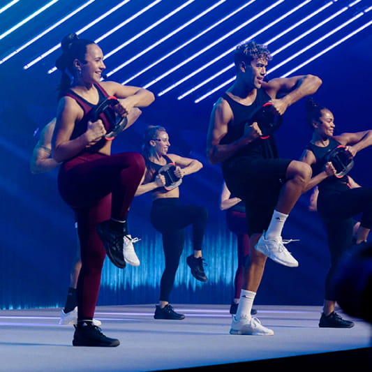 A group of Instructors demonstrating a Les Mills Core workout