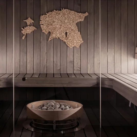 Sauna with steam rocks in foreground and cork decoration in background 