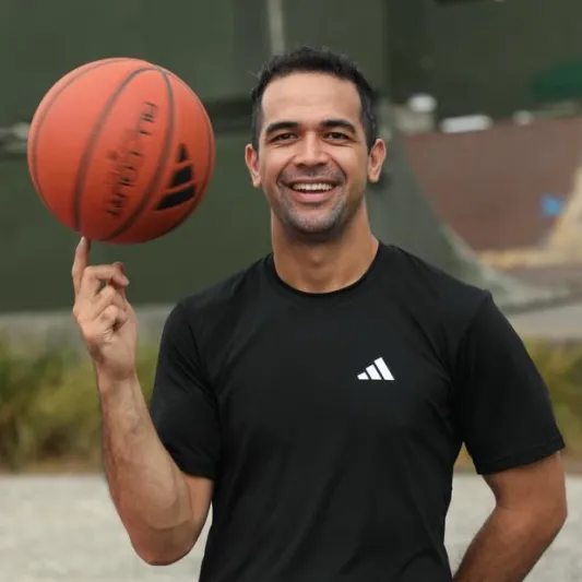 Erin Ripley holding a basketball and smiling at the camera