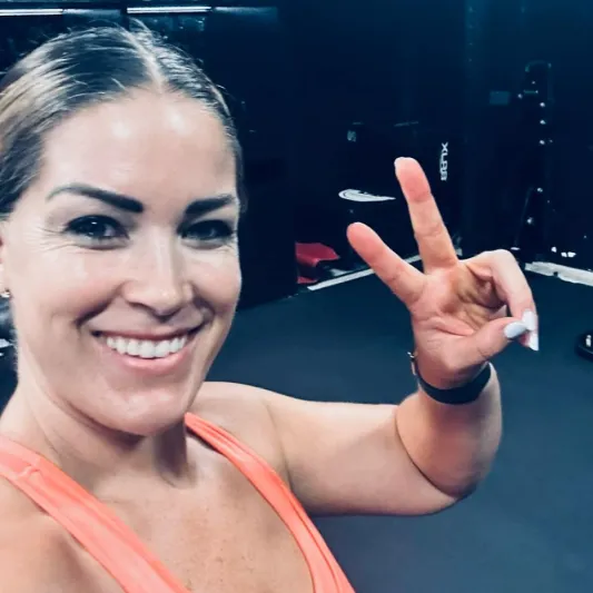 Vibeke O'Donnell looking at camer and doing the peace sign with her fingers