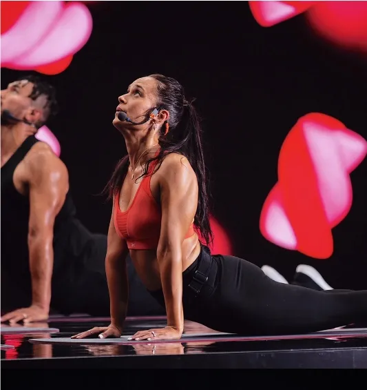 Les Mills Instructor Khiran Huston performing upward-facing dog yoga pose