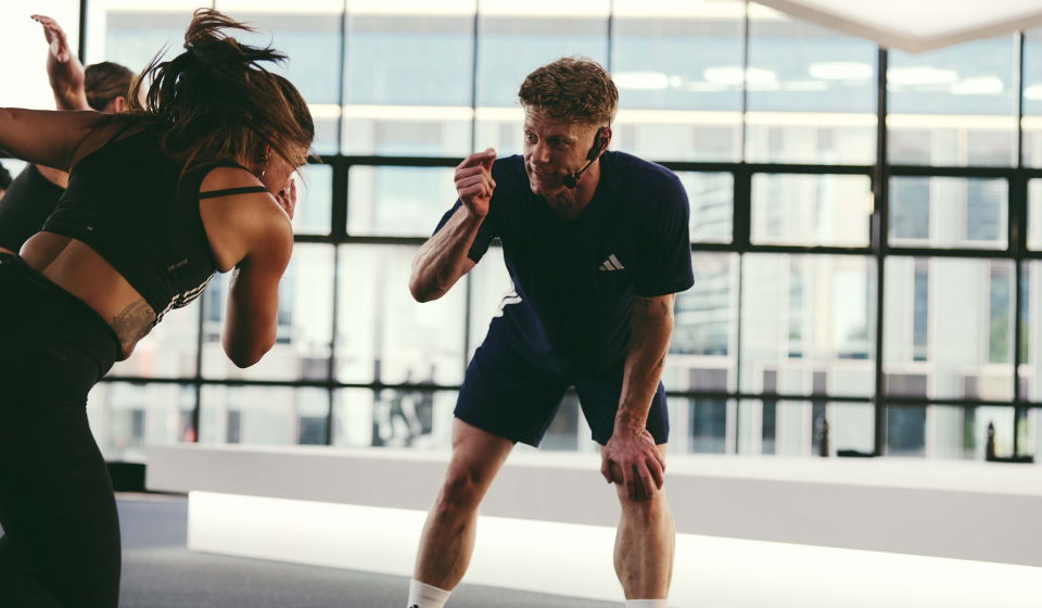 An instructor encouraging a participant mid workout