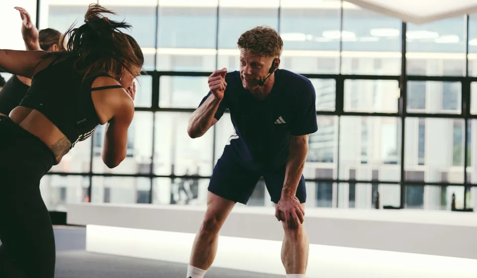 An instructor encouraging a participant mid workout