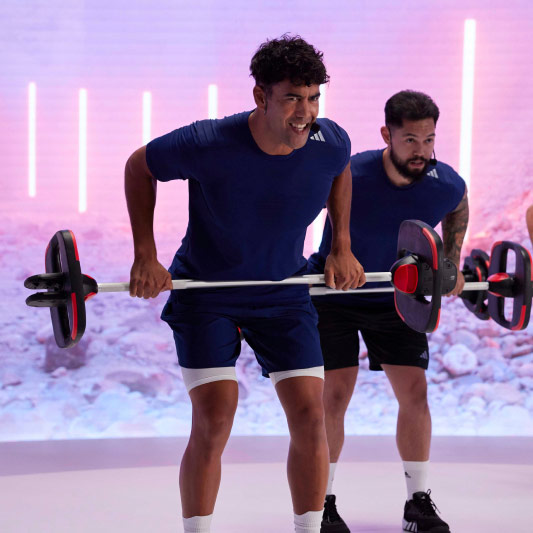 a les mills instructor holding a smartbar