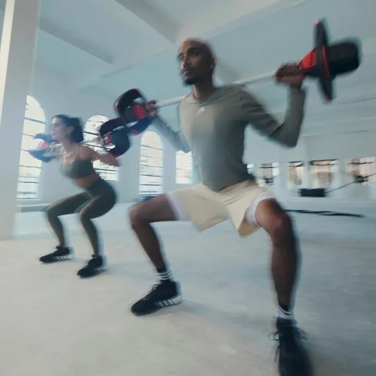 blurry image of two people lifting weights