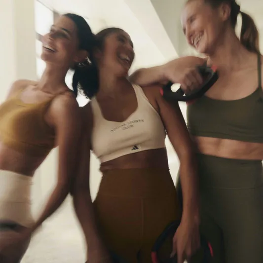 blurry picture of three ladies in athletic clothes